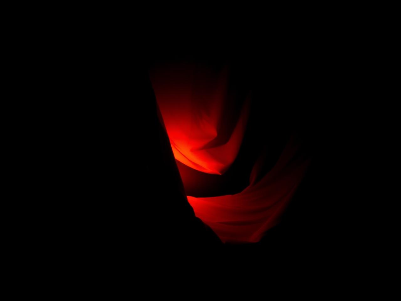 Draped fabric lit by deep orange light, part of the Vellum Studio print identity